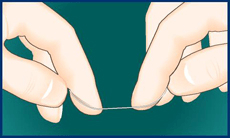 Hands holding dental floss before wrapping it around the fingers.