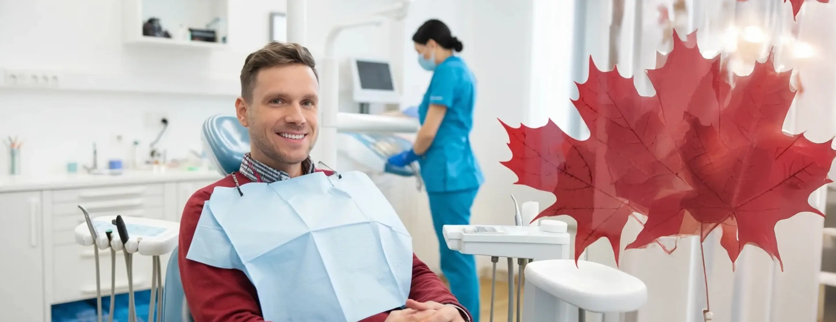 Man seated in a dental chair wearing a protective bib, with dental staff and red maple leaves in a clinic setting