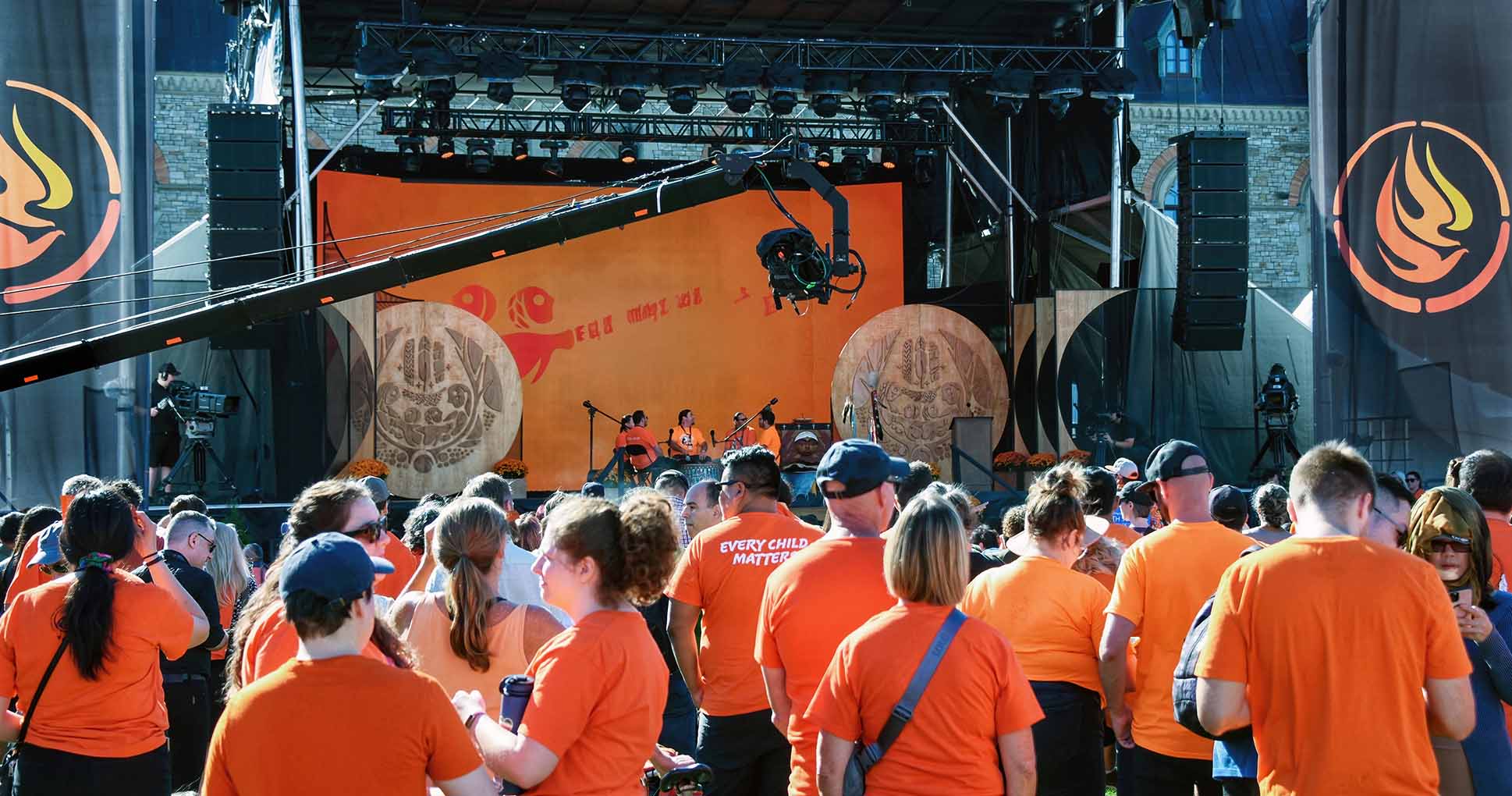 crowd gathered wearing orange shirts