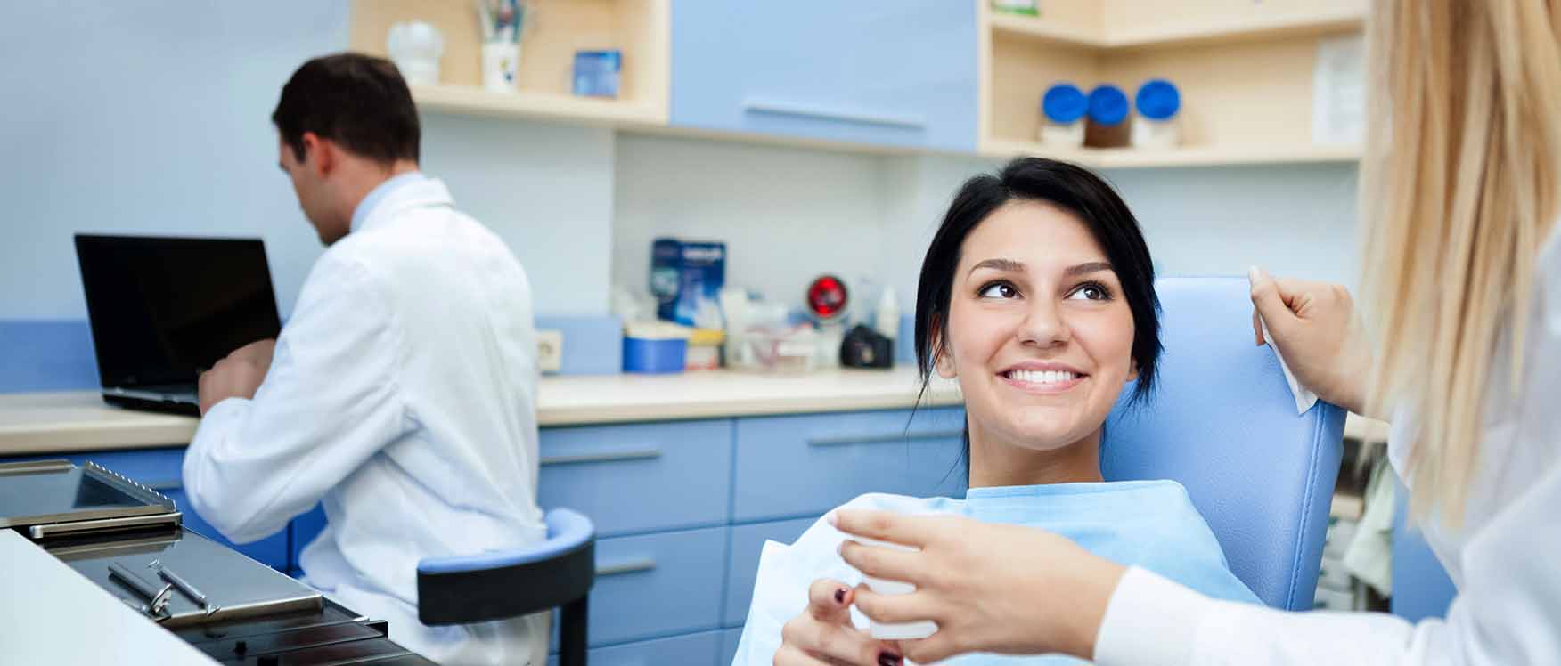 woman with dentist and dental assistant
