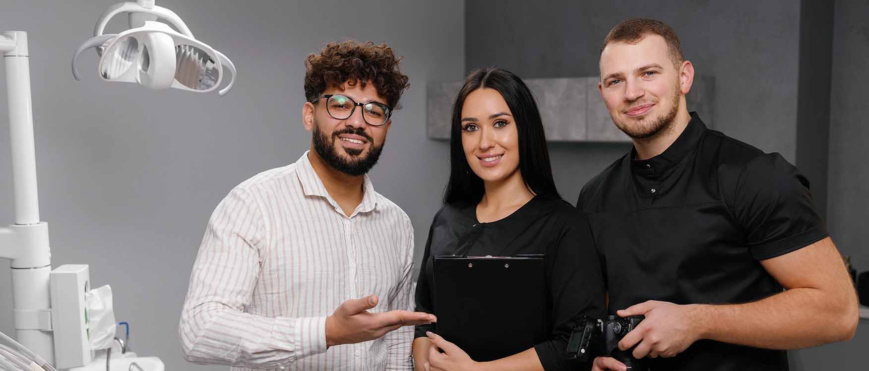 Dental workers smiling in office