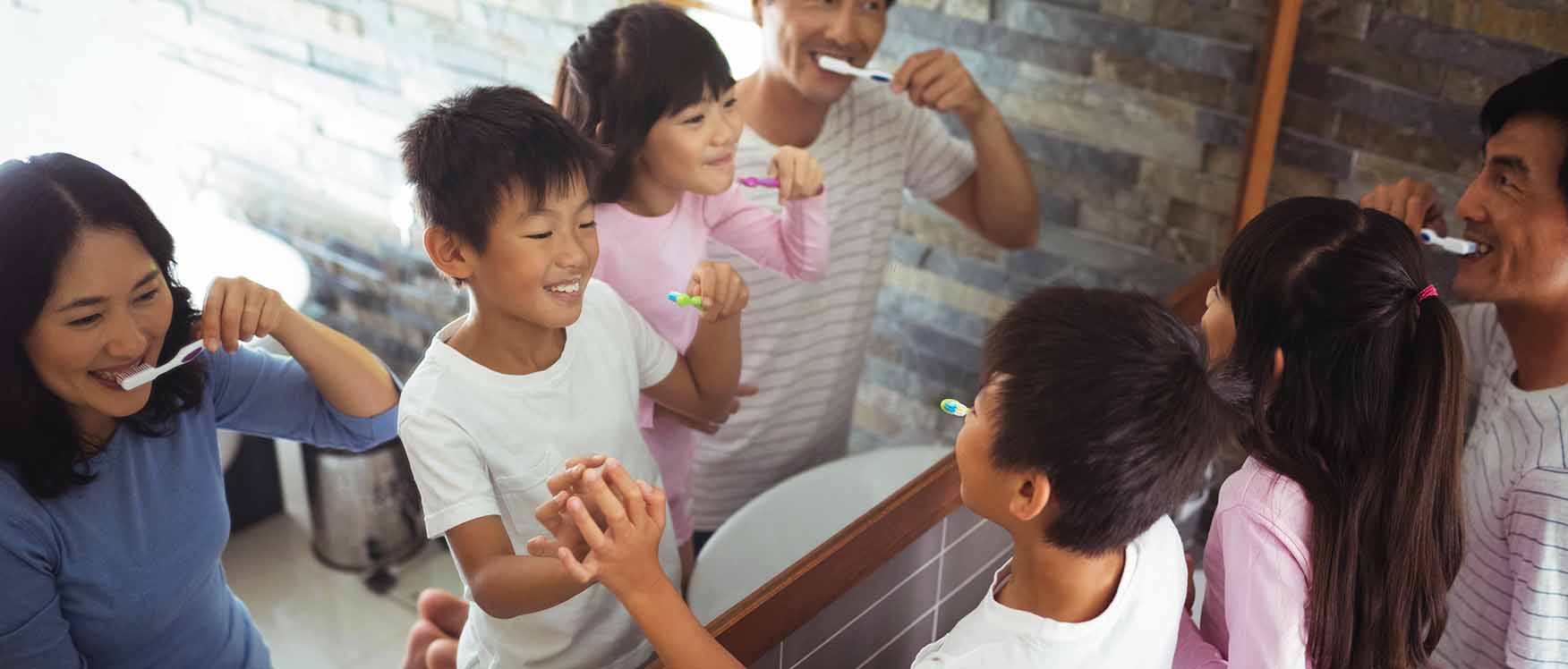 Family brushing teeth together