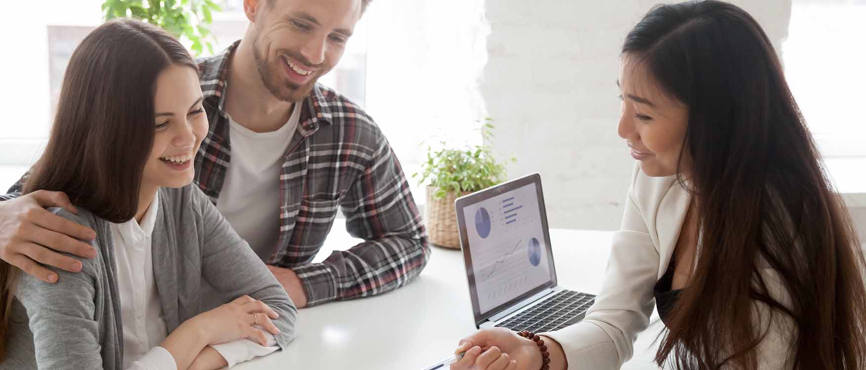 smiling couple talking to insurance woman