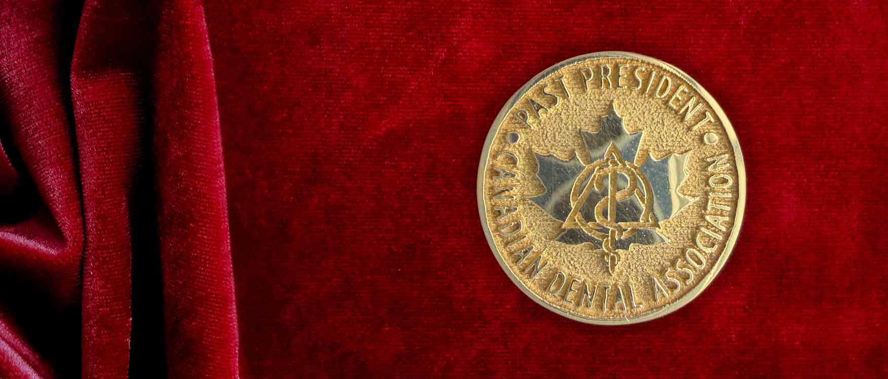 CDA pin on red background