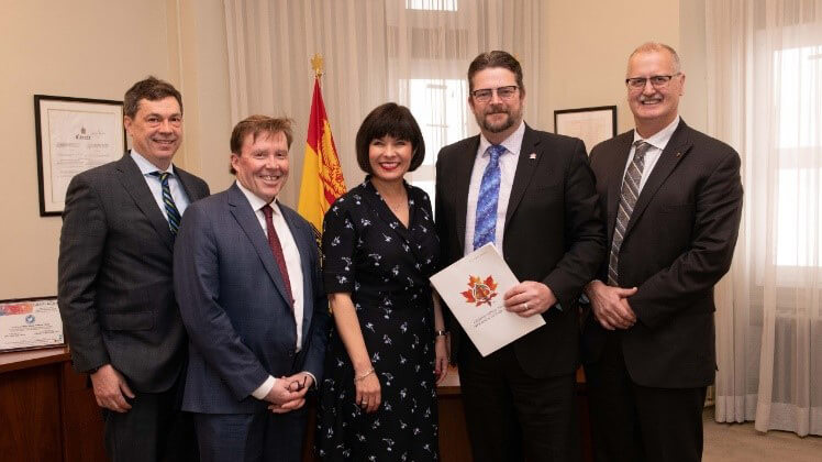 Canadian Dental Association representatives meeting with Health Minister Ginette Petitpas Taylor in May 2019. Five people standing together in an office.